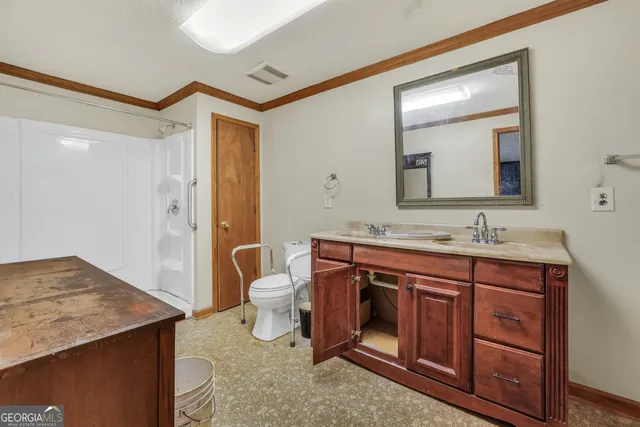 a spacious bathroom with a granite countertop sink and a mirror