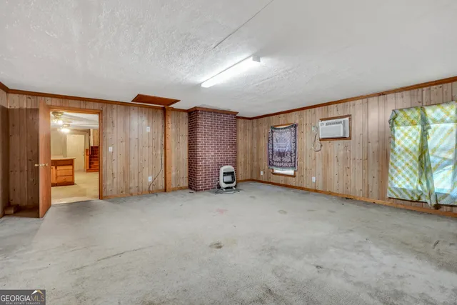 an empty room with furniture and a window