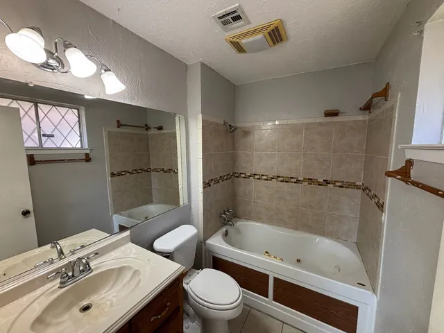 a bathroom with a sink toilet tub and shower