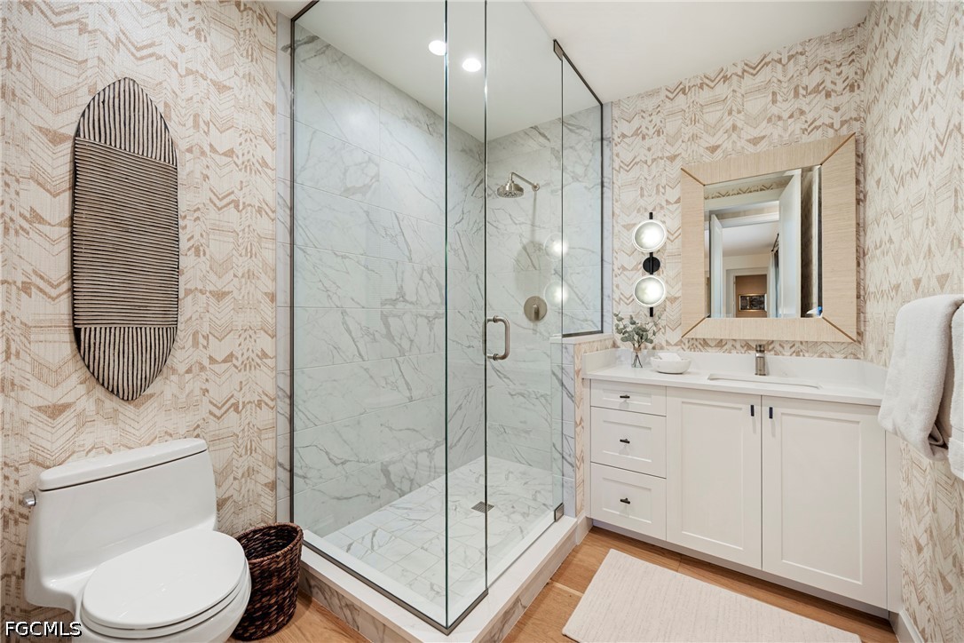 1115 Central Avenue, Unit 443 Naples, FL 34102 - Photo 16 of 40 a bathroom with a toilet sink and shower
