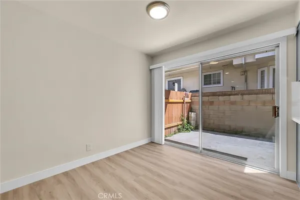a view of livingroom with wooden floor and a bathroom