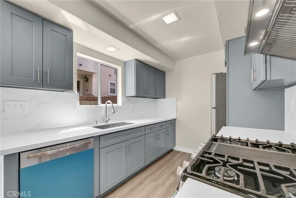 a kitchen with a sink stove and cabinets