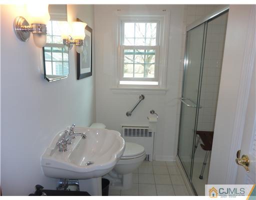 290 Georges Road Dayton, NJ 08810 - Photo 11 of 22 a bathroom with a sink and mirror with toilet