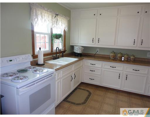 290 Georges Road Dayton, NJ 08810 - Photo 7 of 22 a kitchen with granite countertop white cabinets white appliances with a sink and dishwasher
