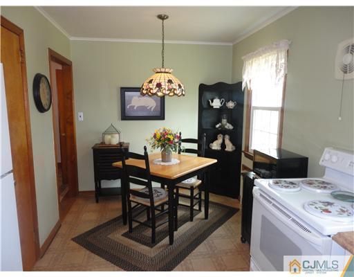 290 Georges Road Dayton, NJ 08810 - Photo 8 of 22 a dining room with furniture a chandelier and window