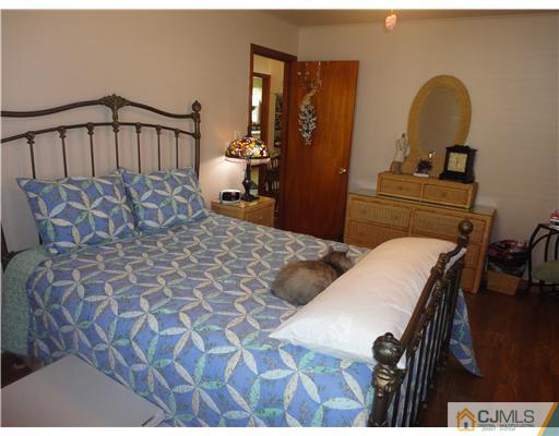 290 Georges Road Dayton, NJ 08810 - Photo 9 of 22 a bedroom with a bed and a dresser