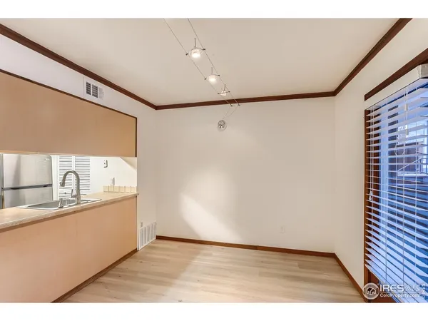 a kitchen with stainless steel appliances granite countertop a sink and a refrigerator