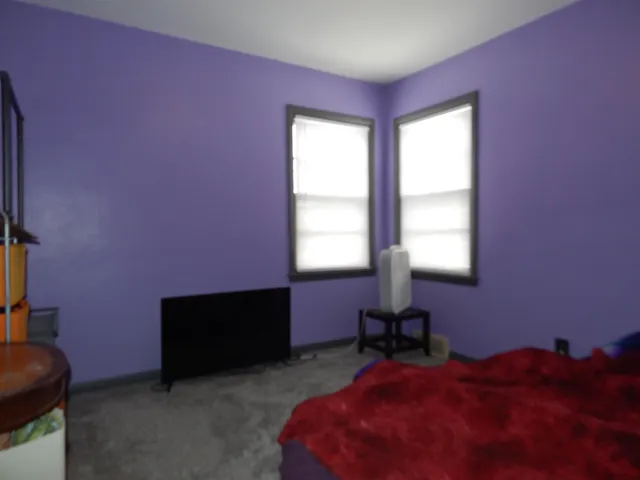 a bed room with a bed and a window