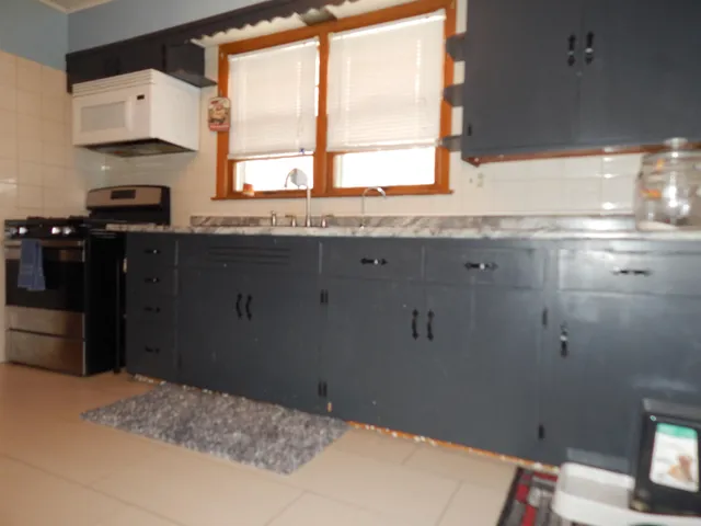 a kitchen with a window wooden floor and a sink