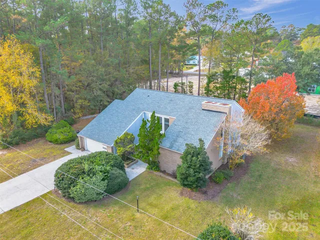 an aerial view of a house with a yard