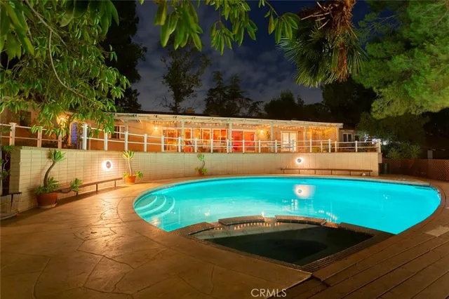 a view of a swimming pool with an outdoor space and seating area