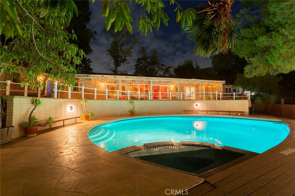 5798 Penland Road Hidden Hills, CA 91302 - Photo 6 of 13 a view of a swimming pool with an outdoor space and seating area