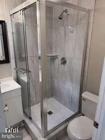 a bathroom with a shower toilet and sink