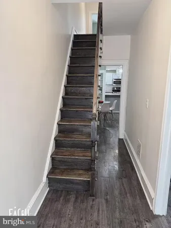 an empty room with wooden floor and closet
