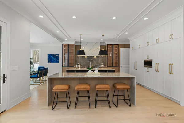 a large kitchen with a table and chairs