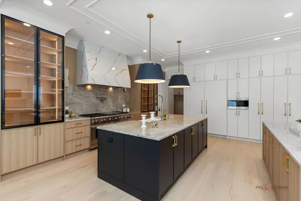 a kitchen with stainless steel appliances granite countertop a sink and a stove