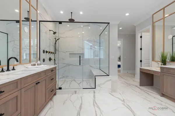 a bathroom with a double vanity sink mirror and shower