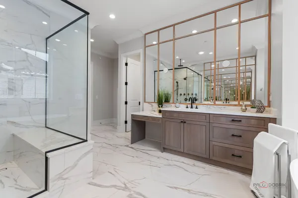 a bathroom with a double vanity sink mirror and shower