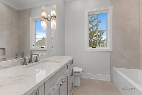 a bathroom with a sink a toilet and a bathtub