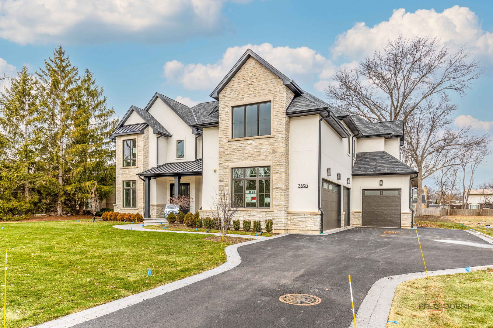 3890 Greenacre Drive Northbrook, IL 60062 - Photo 3 of 37 a front view of a house with a yard garage and outdoor seating