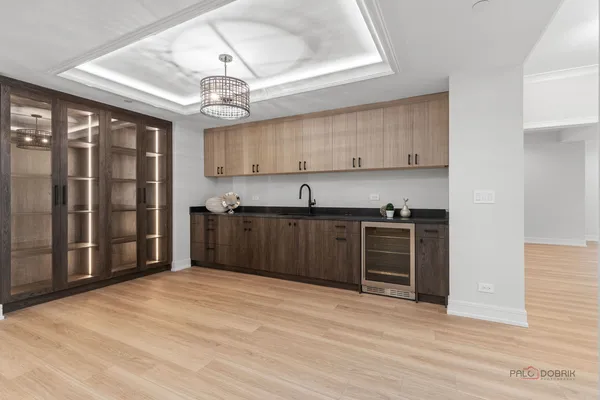 a view of kitchen with granite countertop cabinets and refrigerator