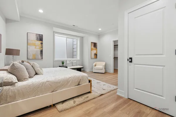 a spacious bedroom with a bed and a couch