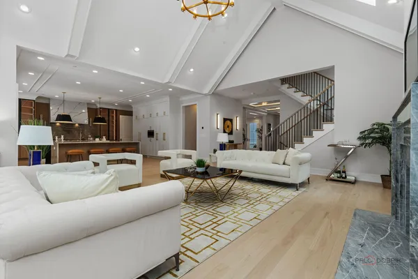 a living room with furniture and a view of kitchen