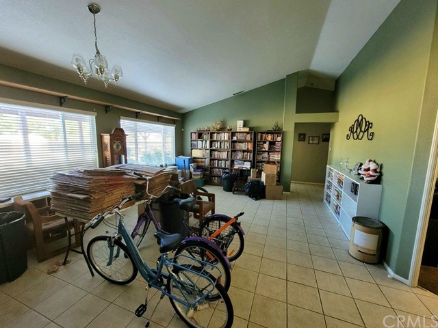 12915 Lompoc Road Apple Valley, CA 92308 - Photo 11 of 23 a room with lots of wooden furniture and a chandelier