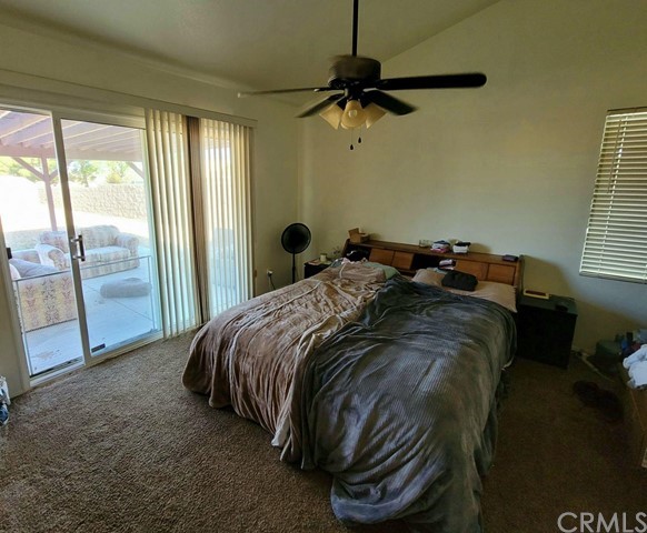 12915 Lompoc Road Apple Valley, CA 92308 - Photo 12 of 23 a bed sitting in a bedroom next to a window