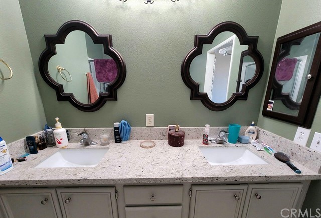 12915 Lompoc Road Apple Valley, CA 92308 - Photo 14 of 23 a bathroom with a granite countertop double vanity sinks and a mirror
