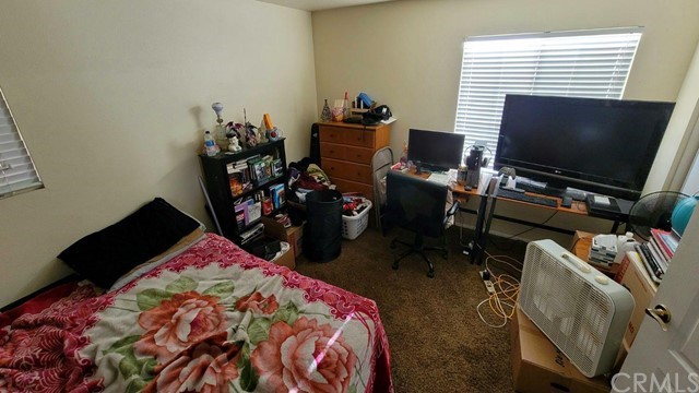 12915 Lompoc Road Apple Valley, CA 92308 - Photo 15 of 23 a bedroom with a bed and a flat screen tv