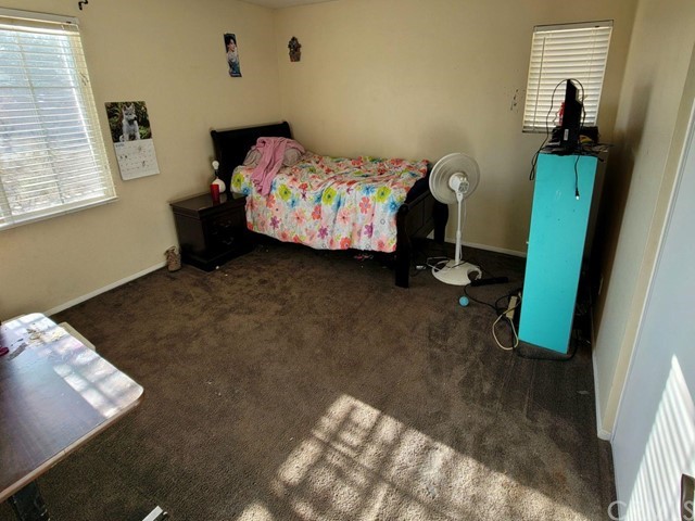 12915 Lompoc Road Apple Valley, CA 92308 - Photo 16 of 23 a bedroom with a bed and furniture