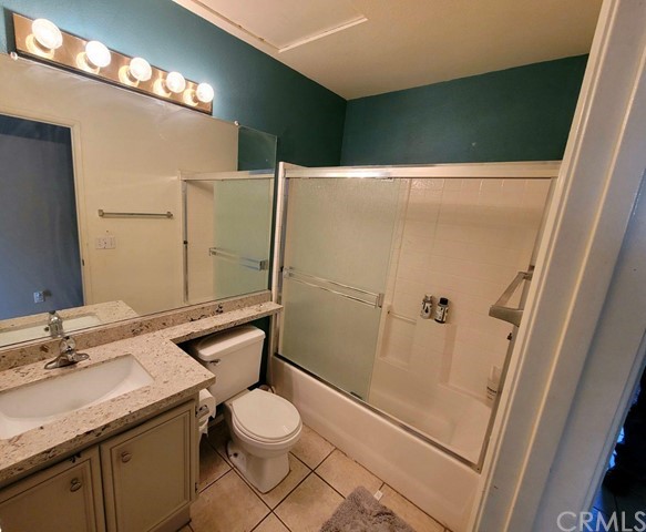 12915 Lompoc Road Apple Valley, CA 92308 - Photo 17 of 23 a bathroom with a granite countertop sink toilet and shower
