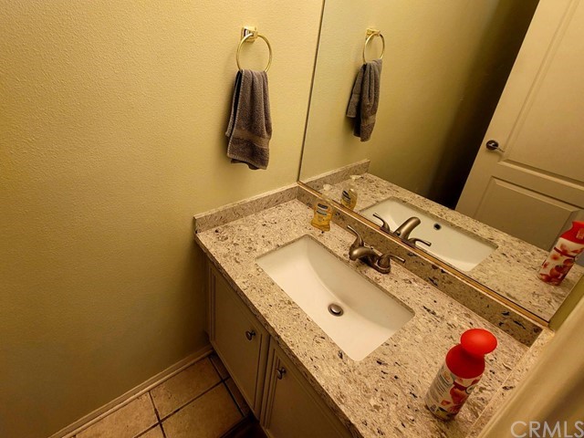 12915 Lompoc Road Apple Valley, CA 92308 - Photo 19 of 23 a bathroom with a granite countertop sink and a shower