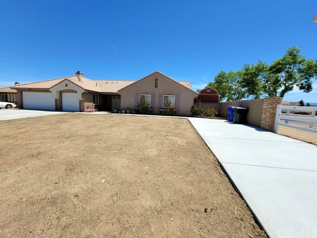 12915 Lompoc Road Apple Valley, CA 92308 - Photo 3 of 23 a front view of a house with a yard