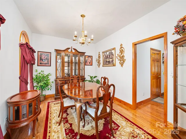 a view of a dining room with furniture and a chandelier