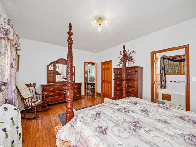 a bedroom with furniture and wooden floor