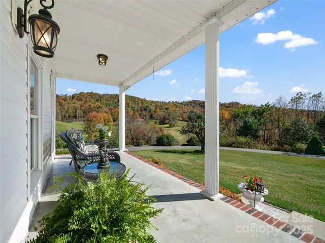a view of a porch with furniture and yard