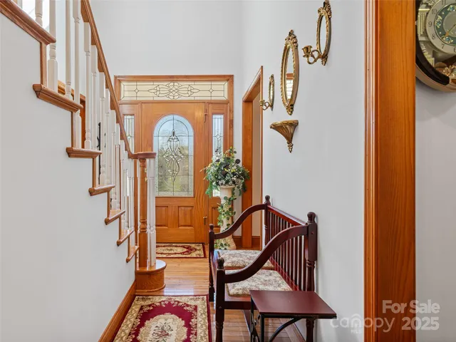 a view of a hallway with wooden floor and entryway