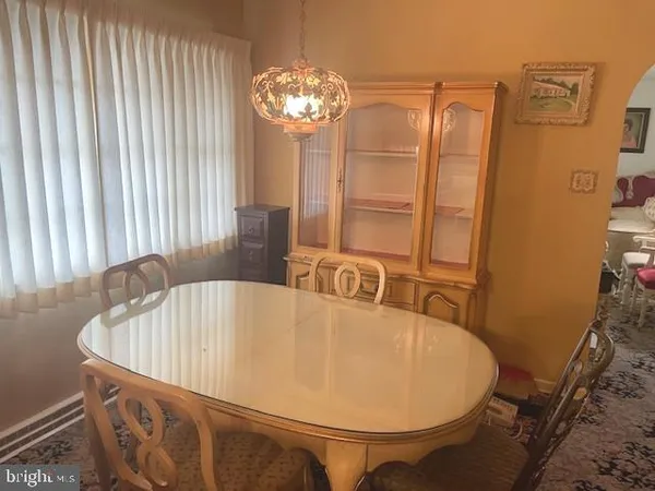 a bathroom with a tub a sink and a mirror