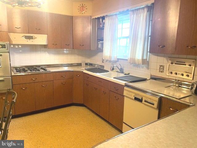 2146 Fairview Avenue Reading, PA 19606 - Photo 14 of 25 a kitchen with a sink a stove cabinets and a wooden floor