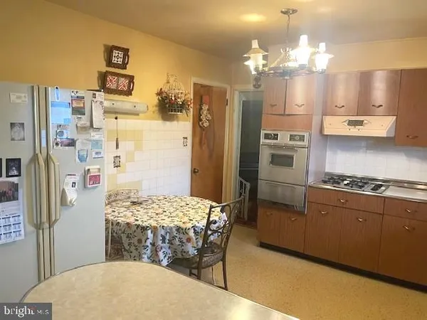 a kitchen with stainless steel appliances a refrigerator sink and stove