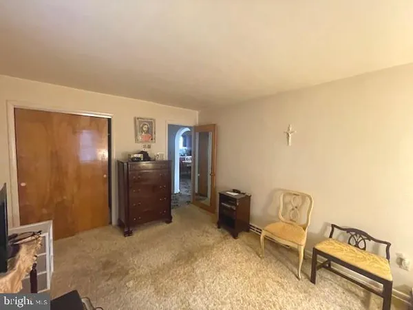 a view of a livingroom with furniture and a refrigerator