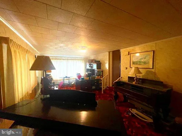 a living room with a table and a potted plant