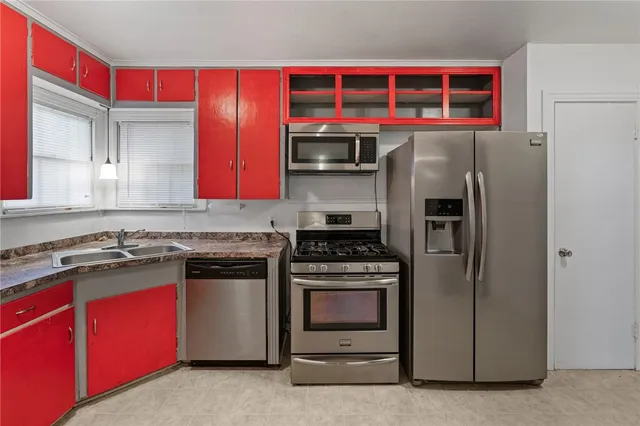 a kitchen with stainless steel appliances granite countertop a stove and a refrigerator