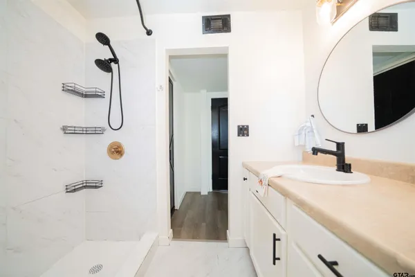 a bathroom with a sink and mirror