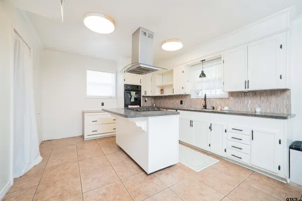 a kitchen with granite countertop white cabinets white stainless steel appliances with a sink and dishwasher