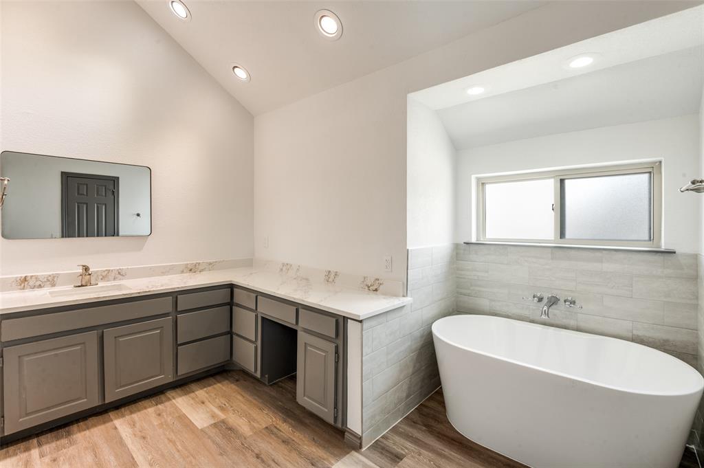 17079 Upper Bay Road Addison, TX 75001 - Photo 13 of 24 a bathroom with a tub sink and mirror