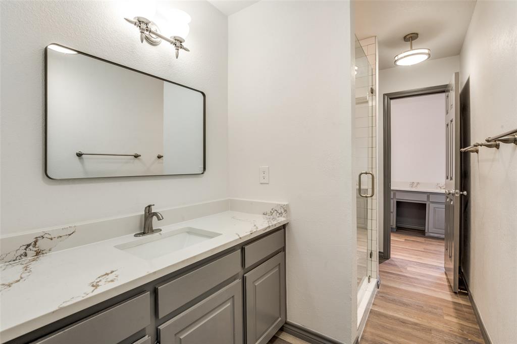 17079 Upper Bay Road Addison, TX 75001 - Photo 14 of 24 a bathroom with a sink and a mirror
