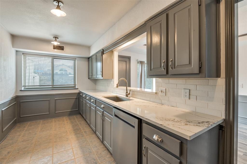 17079 Upper Bay Road Addison, TX 75001 - Photo 3 of 24 a bathroom with a granite countertop sink a mirror and a bathtub